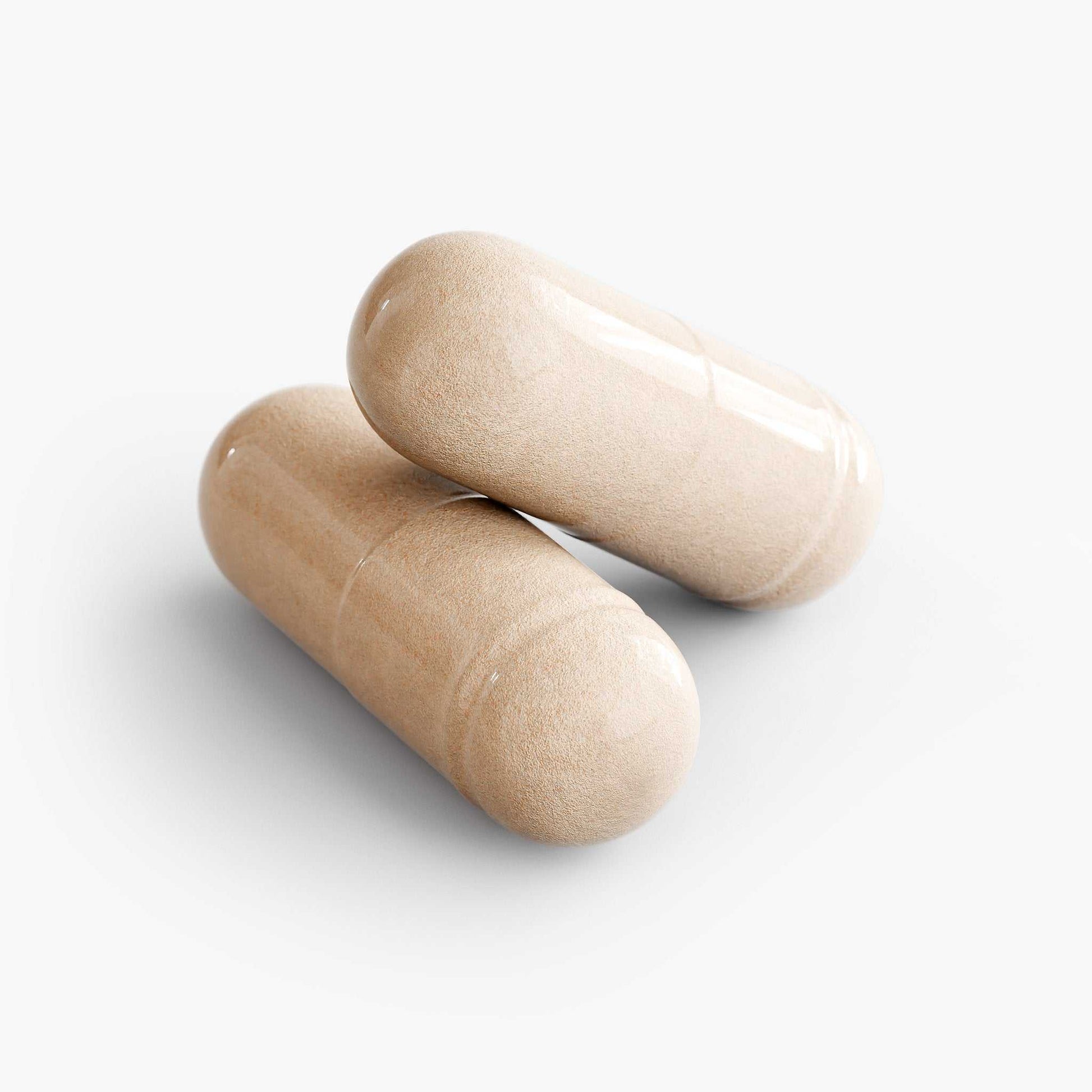 Two beige ashwagandha capsules representing an ancient herb used for stress relief and overall health support