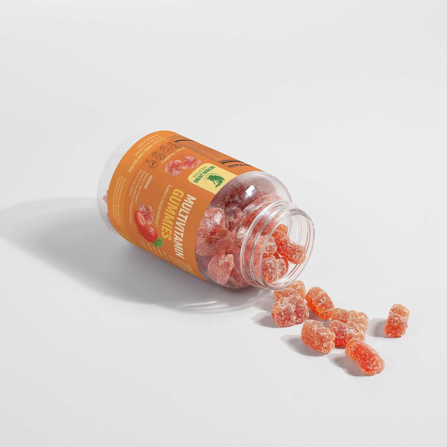 Bottle of strawberry-flavored Multivitamin Bear Gummies for adults with gummies spilling out on white background