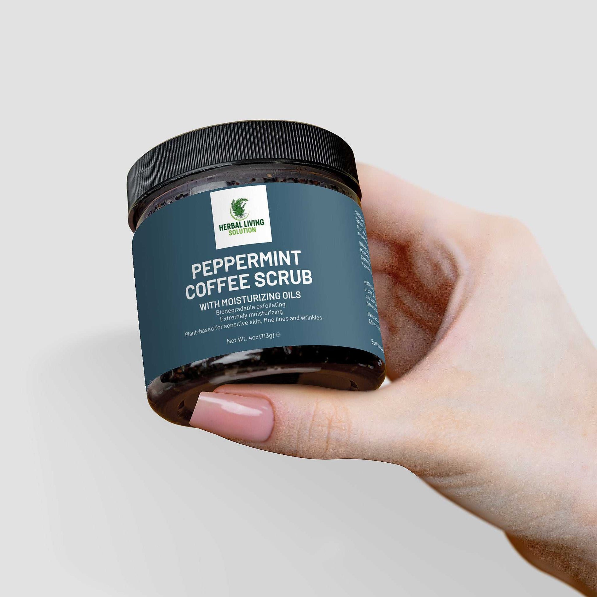 Hand holding jar of Peppermint Coffee Scrub with moisturizing oils for exfoliation and skin rejuvenation